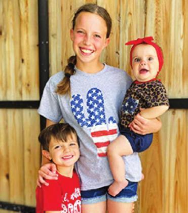 Hunter, Rylee, and Rowan Larsen wear cute patriotic outfits.