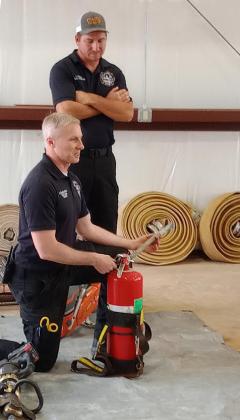 Fire Chief Seth Slaughterback explains to students the ins and outs of a fire extinguisher.PHOTO BY HEATHER FLORES