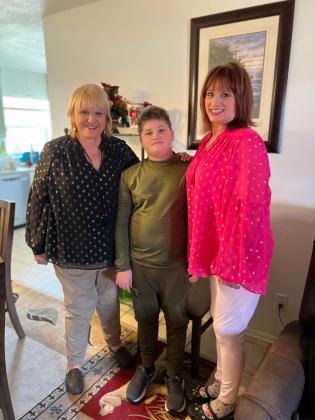 Kody Belding with his grandmother (left) and his mother (right)