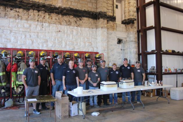 Cordell Fire Department serve smoked sausage and turkey breasts to the community