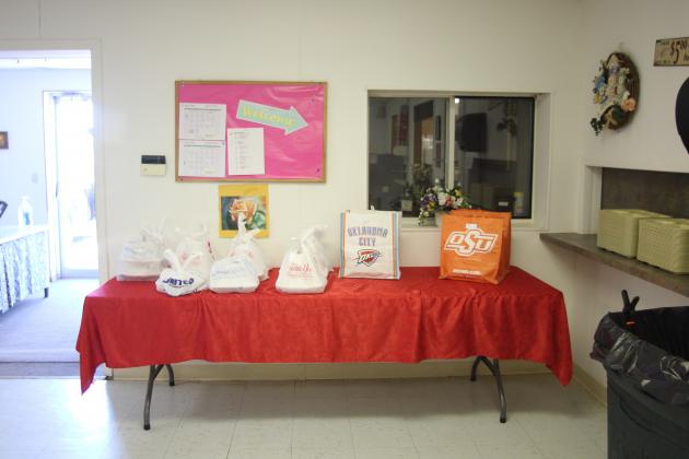 To-go orders sit ready to be delivered by volunteers to those unable to visit the meal site
