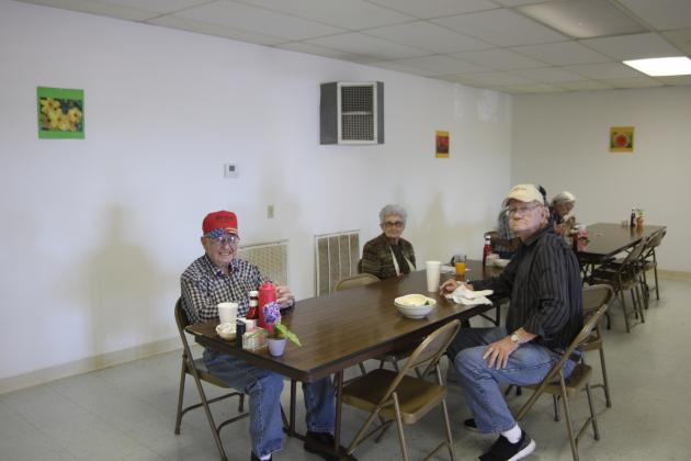 Senior citizens enjoy their lunch and the good company of one another.