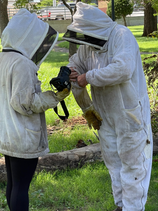 Beacon reporter Brooklynn Peek dons a protective suit and gloves in order to get right into the action at Lee Park. Photo by Heather Flores