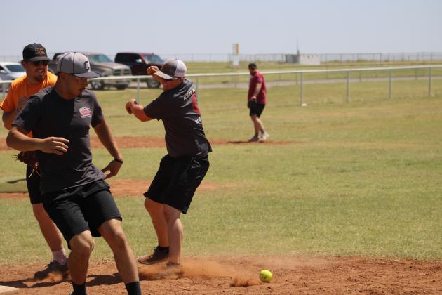 Mason Helvey gets struck with the ball in a failed attempt to return to first base. Photo by Brooklynn Peek