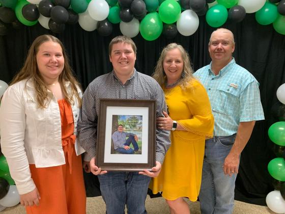 Jacob Baker (center) was presented with the prestigious Hall of Fame award at the 2022 Washita County 4-H Awards Program. The Hall of Fame award is the highest honor given by the Washita County club