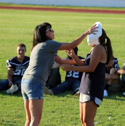 Carmen Nickel pies her daughter Camryn Nickel. Photo from previous Annual Pie Auction and Meet the Players.
