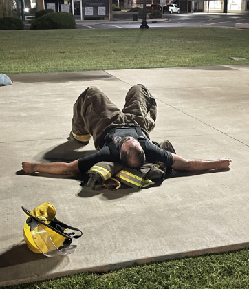 Fireman Eric Vandever rests on the ground. Photo by Brooklynn Peek