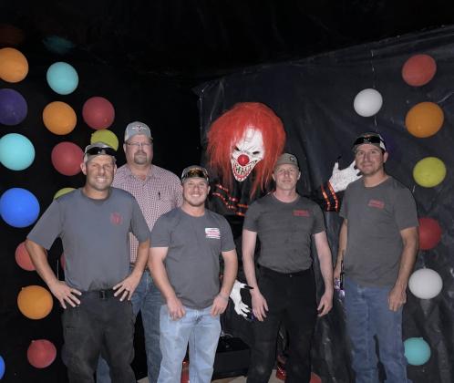 Cordell Fire Department Firemen pose in front of an attraction at the Haunted Morgue (Left to right) Heath Syfert, Levi Jones, Donald Mitchell, Seth Slaughterback, Lincoln Hunter