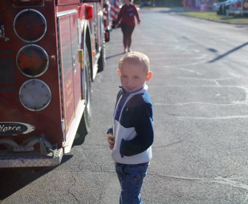 Baylor Cook stands next to a Cloud Chief Fire Truck