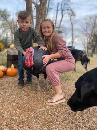 Whitten and Waverly Schneberger with their pet turkey, Tommy.