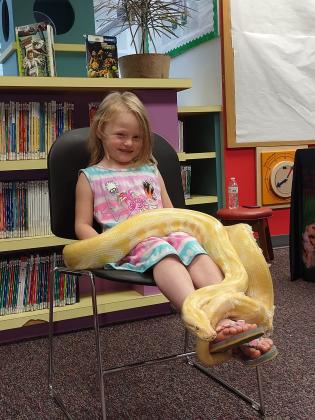 Dustie King spends time with a slithery friend at last year’s Extreme Animals performance