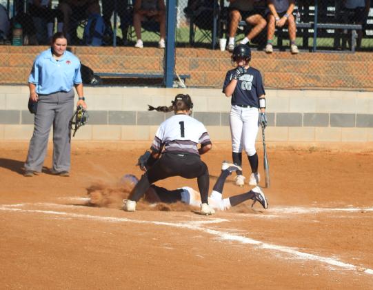 McKinley Moore, #2, sliding safe into home plate