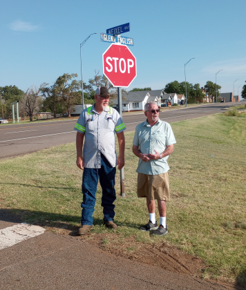 Mike Weixel (left) and Mayor Phil Kliewer stand underneath the new street sign PHOTO BY HEATHER BENAVIDEZ
