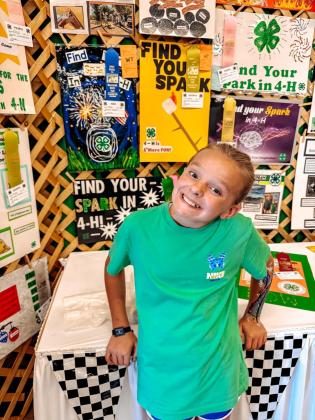 Liberty Lester with her First Place poster at the Oklahoma State Fair. Photo by Natasha Lester.