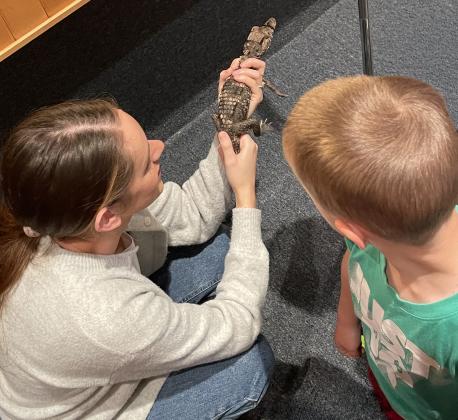 Kaitlyn Evan and Malachi Miller with Chompers the Caiman