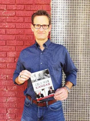 Local author Landry Brewer holds a copy of his new book “Cold War Kansas” which was published last month.
