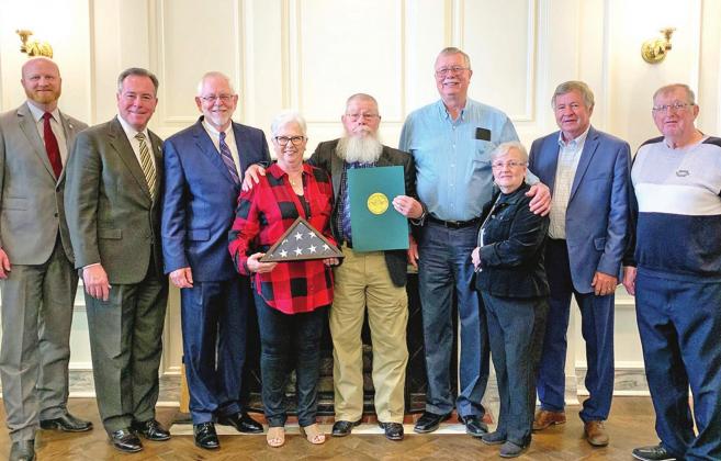 ABOVE: (From left to right) State Sen. Brent Howard, State Rep. Todd Russ, Charles Rainbolt, Jeannie Horn, Denver Horn, Alan Hull, Judy Stalcup Ploch, Don Williams, and Quinton Ploch pose for a photo during Horn’s Veteran of the Week ceremony. BELOW: Denver and Jeannie Horn as Denver Horn is recognized by State Rep. Todd Russ at the podium. CONTRIBUTED PHOTOS