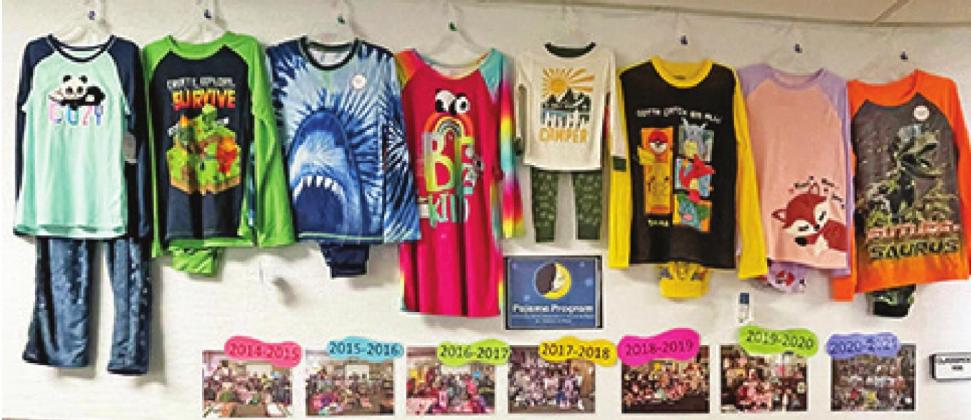 Left: A wall display in the hall outside Mrs. Powers’ classroom shows photos from the past seven years’ successful pajama drives. CONTRIBUTED PHOTOS