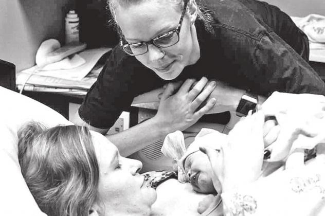 LEFT: Mariah Hanson leans over and watches Tori Ervin with her newborn baby. Hanson provided Ervin with emotional and physical support as a doula. CONTRIBUTED PHOTOS BY MARIAH HANSON