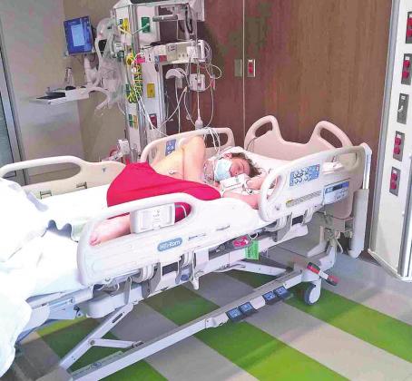 Mason Curnett rests in his hospital bed. He’s been undergoing chemotherapy treatments. CONTRIBUTED PHOTO