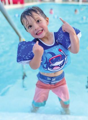 Hunter Larsen enjoys a cool dip in the pool.