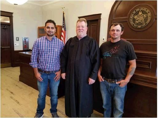 Judge Christopher Kelly, who heads the Washita-Custer County Treatment Court, with two program graduates at their July 3, 2019, graduation. Photo courtesy of Sarah Ivy.