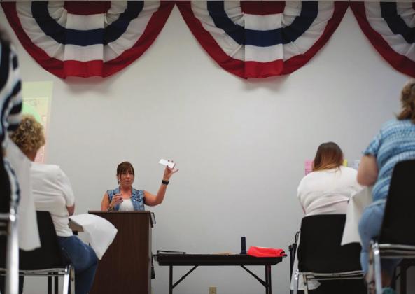 Madelyn Rains, an administrative assistant at the Oklahoma County Election Board, trains poll workers before the June 30 primary. Rains holds up a card with contact information that will be given to each worker in case they have questions or encounter a problem on election day. Whitney Bryen/Oklahoma Watch