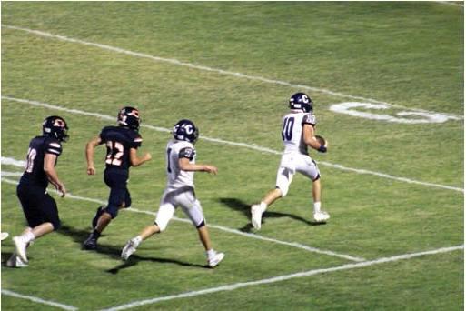 Above: Raydon Kuehne outpaces the Merritt tacklers en route to the end zone, scoring on an 85-yard fumble recovery with Adden Zanghi providing blocking support.
