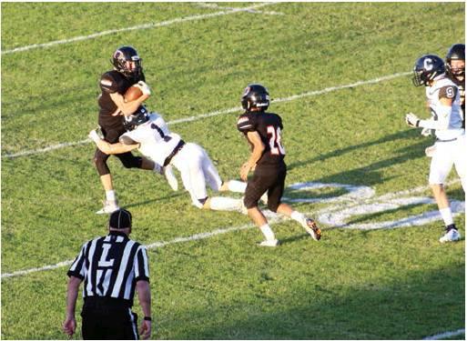 Below: Dane Corbin wraps up the Merritt running back for a loss. Bob Henline | The Cordell Beacon