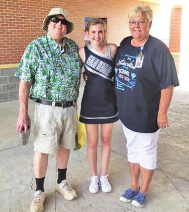 Bob and Charlinda Ogle pose with one of their “kids”, cheerleader Taylor Javorsky, daughter of Keith and Raquel Javorsky. CONTRIBUTED PHOTO