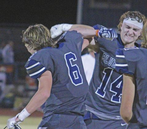 BOTTOM LEFT: Cordell football players Bode Gallagher and Blaine Larsen lock arms triumphantly. The Blue Devils beat Magnum 39-12.