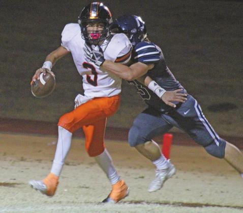 BOTTOM RIGHT: Junior Blaine Larsen surprises the Mangum quarterback, sacking him in the backfield.