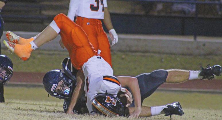 Cordell senior Gavin Jasmer demolishes a Mangum ball carrier in his team’s 39-12 win. The victory set up a Cordell home playoff football game on Friday night. PHOTO BY FLORA WALTERS