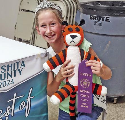 KENDALLYN GOSSEN WITH HER HAND SEWN HOBBES STUFFED TOY AT THE WASHITA CO. FAIR