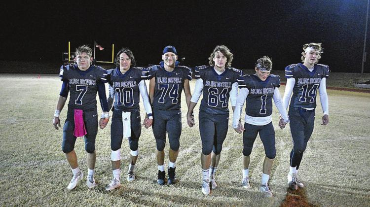 Cordell senior football players, from left, Adden Zanghi, Raydon Kuehne, Gavin Jasmer, Cameron Cochran, Dane Corbin and Bode Gallagher walk the field, hand-in-hand, as part of their post-game tradition. The seniors propelled Cordell to a play off win. COURTESY PHOTO BY CHARLINDA OGLE