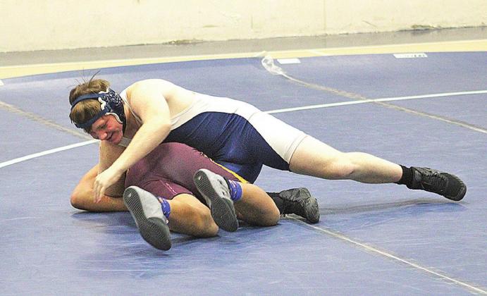 Devon Christian wrestles in a match last season. A knee injury in football derailed his wrestling season this year, but he is helping he team as a manager. 