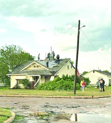 Shortly after the storm ended citizens converged upon the damaged areas to see where they could help and began tarping roofs and gathering limbs COURTESY PHOTO
