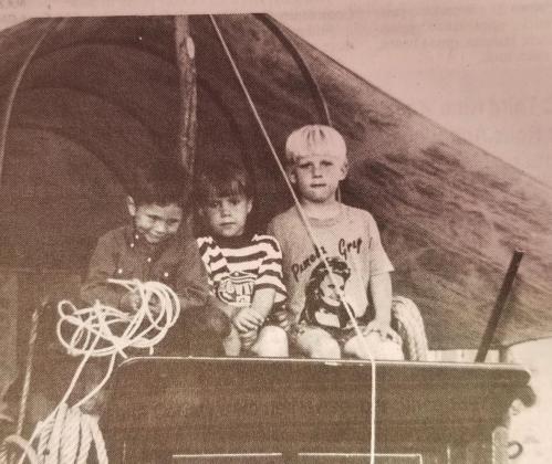 Ryan Merrill, Kolt Gray, and an unidentified poke check out the view from the top of a wagon.