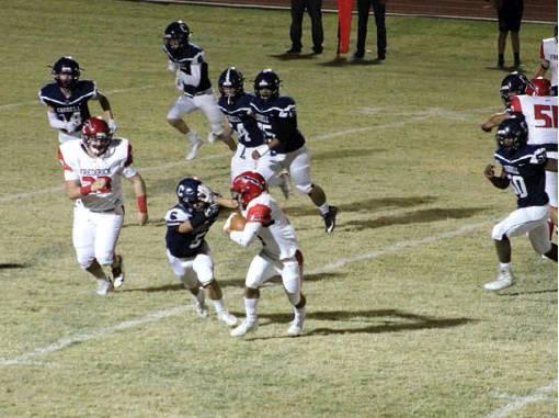 Blaine Larsen cuts off the Frederick running back’s move to the outside while other Blue Devil defenders converge on the play. Bob Henline } The Cordell Beacon