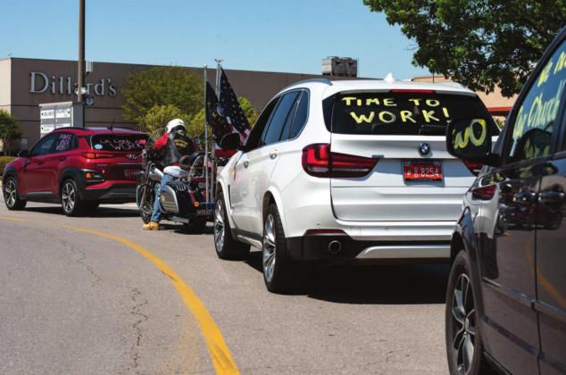 A line of cars waits to exit Penn Square Mall in Oklahoma City April 15 before driving to the State Capitol. The rally, organized by a group called OK Back 2 Work, was intended to push state leaders to lift business closures enacted because of the pandemic. Whitney Bryen | Oklahoma Watch