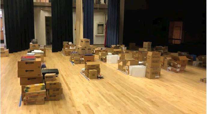 Stacks of school supplies being prepared for Cordell Elementary classrooms, thanks to the School Supply Project. Photo courtesy of Brooke Dodd.