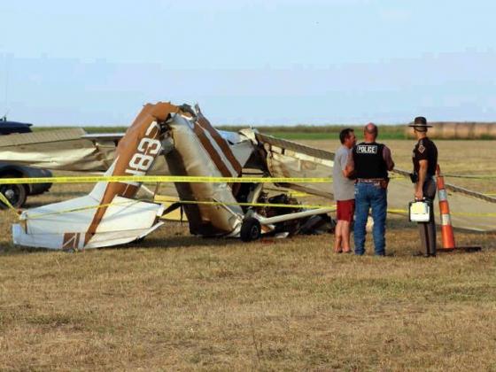 Emergency responders look over the wreckage of Devin Humphrey’s Cessna 150 last Friday night after the plane crashed while attempting to land. The cause of the crash remains under investigation by the FAA. Bob Henline | The Cordell Beacon
