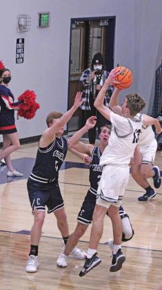 Brady Reimer and Cade Walker attempt to block a shot from their opponent