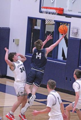  Senior Bode Gallagher charges past a Minco bulldog and sinks a layup