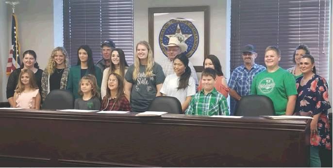 The Washita County Board of Commissioners with local 4-H students after signing the 2019 4-H Week Proclamation. Front, from left: Francesca Bloomer, Kali Bloomer, Vanessa DeRoin, Braxton Barnett. Back: Kristen Dowell, Makia Maxey, Jordan Mason, Leo Goeringer, Logan Davis, Kyla Bloomer, Steve Tompkins, Marcie Diggs, Gabby Espinosa, Bart Gossen, Brance Barnett, Dana Church (Washita Co. 4-H Extension Educator), Larissa Mason (BF-DC Senior Leader). Bob Henline | The Cordell Beacon