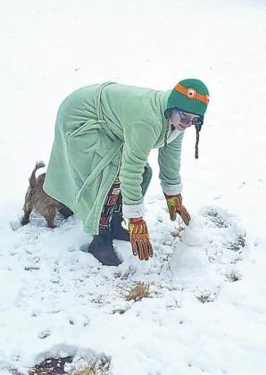 Elizabeth Riggs, 15, works on her mini-snowman.