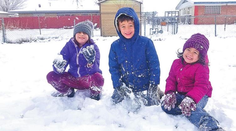 Adilyn, Kamdyn and Charli pose for a picture after their first snowball fight.