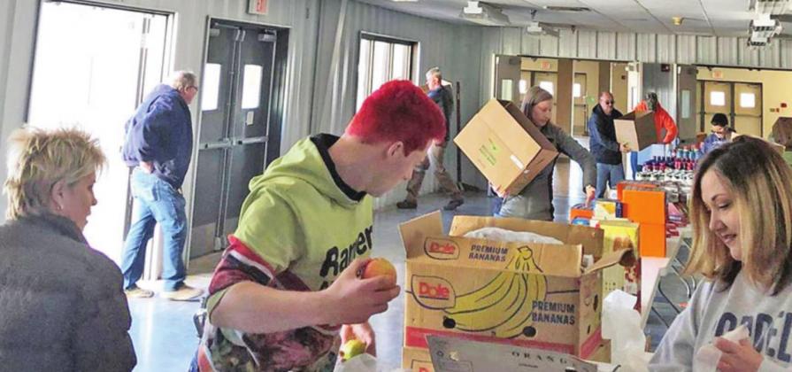 Volunteers prepare and deliver Christmas food boxes to area families