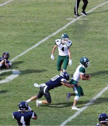 Below right: Cordell QB Aiden Zanghi gets a pass off under pressure.