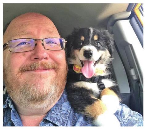 James Newman poses with his dog, Sasha. Newman will stick around to serve another two years on city council.